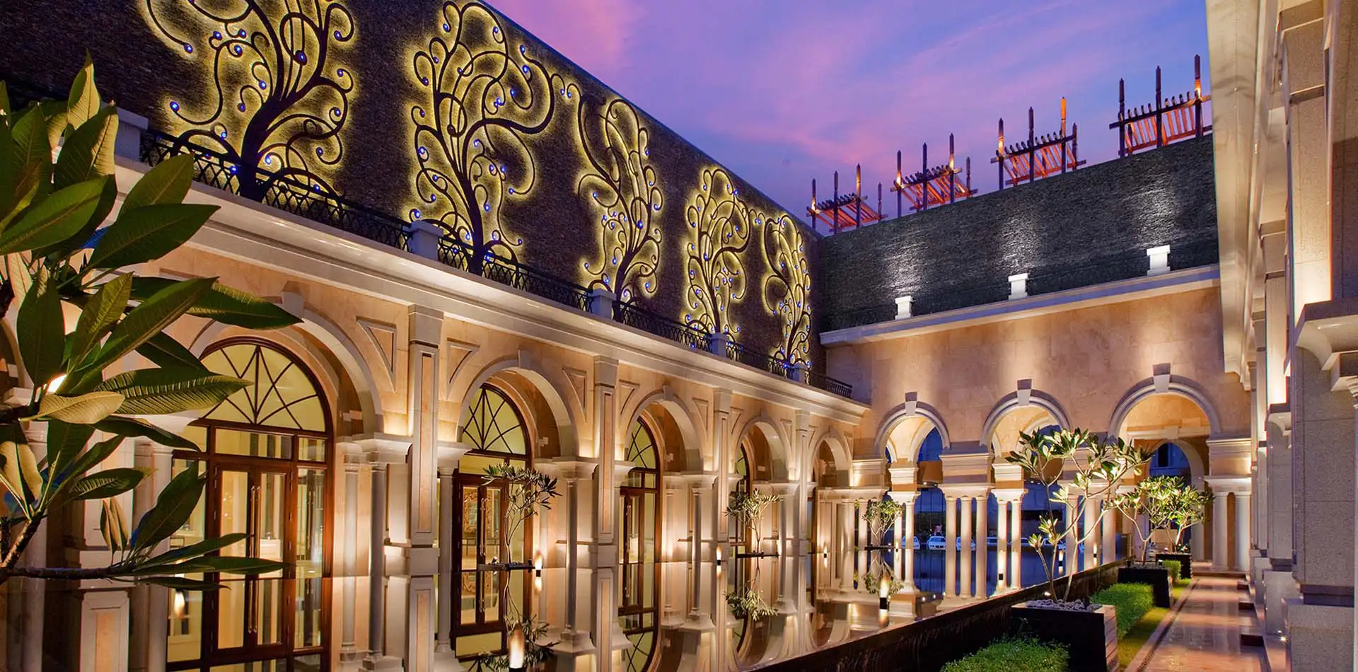 Grand chandelier and marble-lined lobby interior at The Leela Palace Chennai
